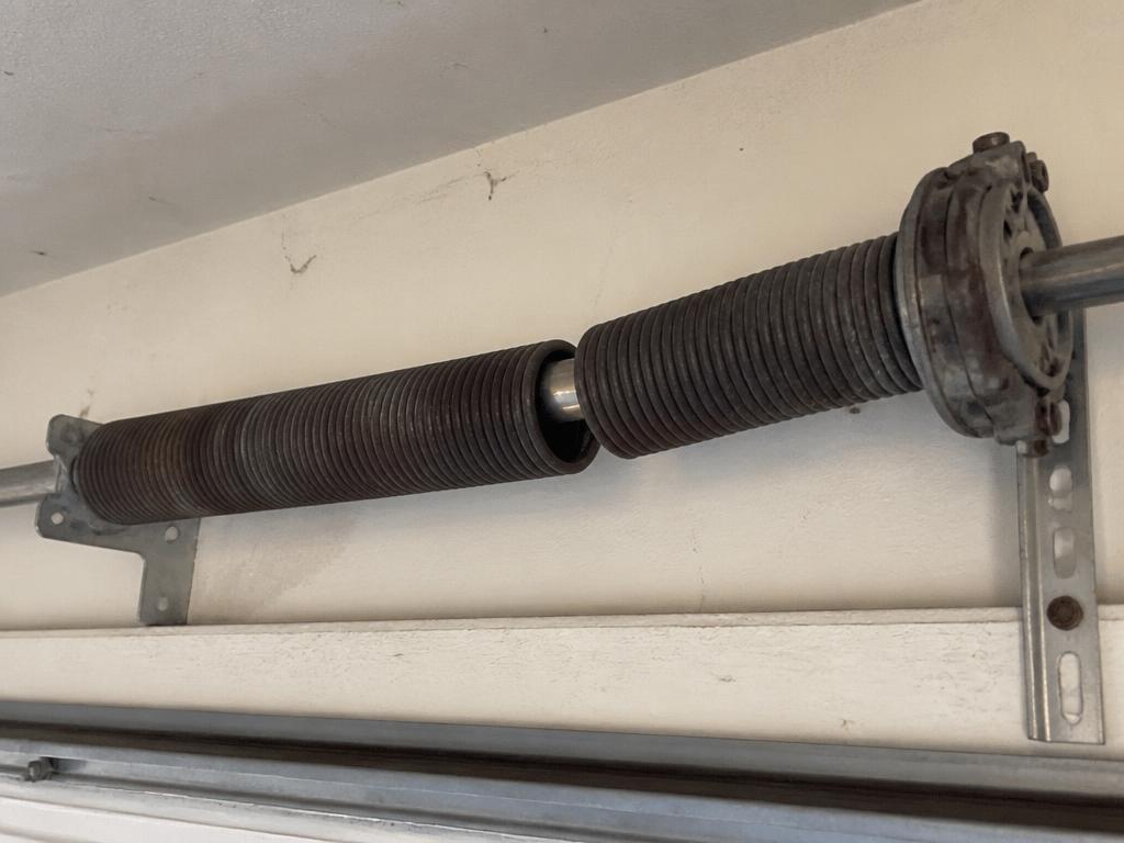 Before: broken spring repair problem on a Sacramento area garage door